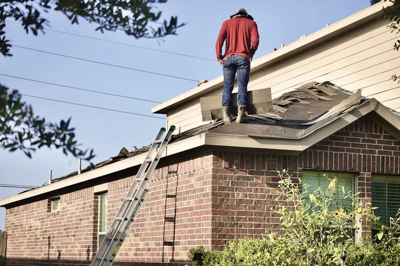 Professional roofer working on a residential roof in Mesquite